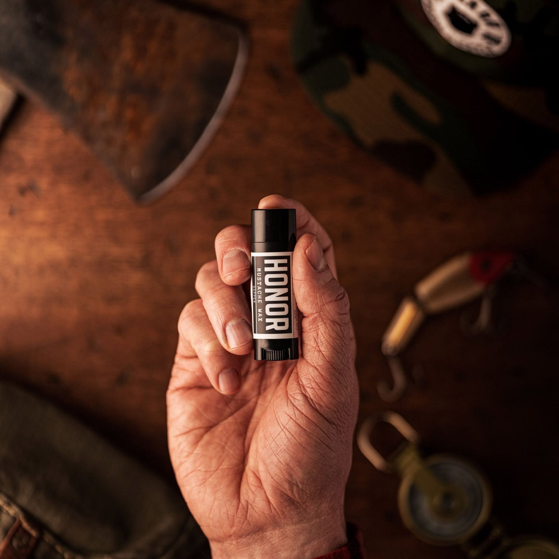 dapper mustache wax in a man's hand