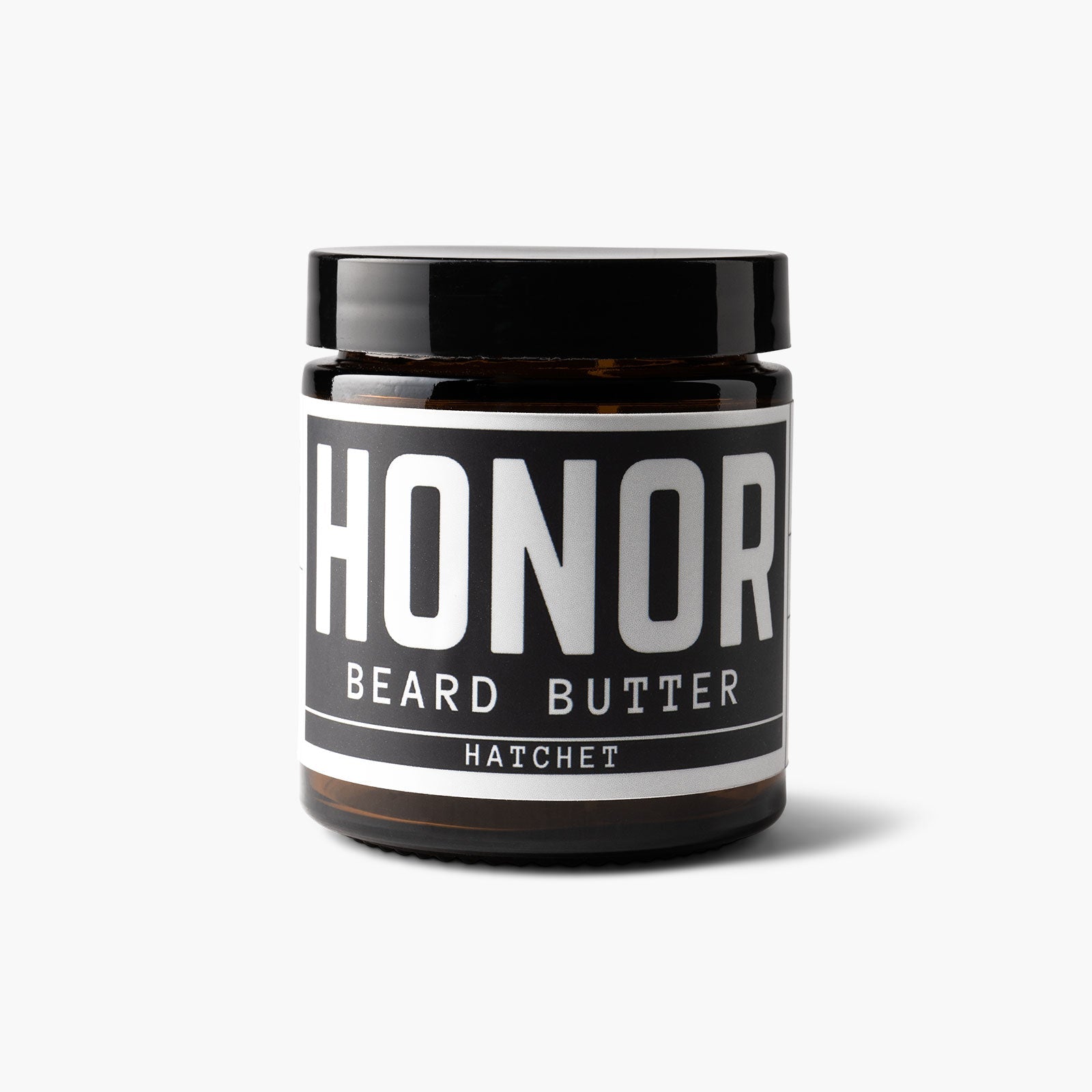 Hatchet blend beard butter on a white backdrop with a light shadow
